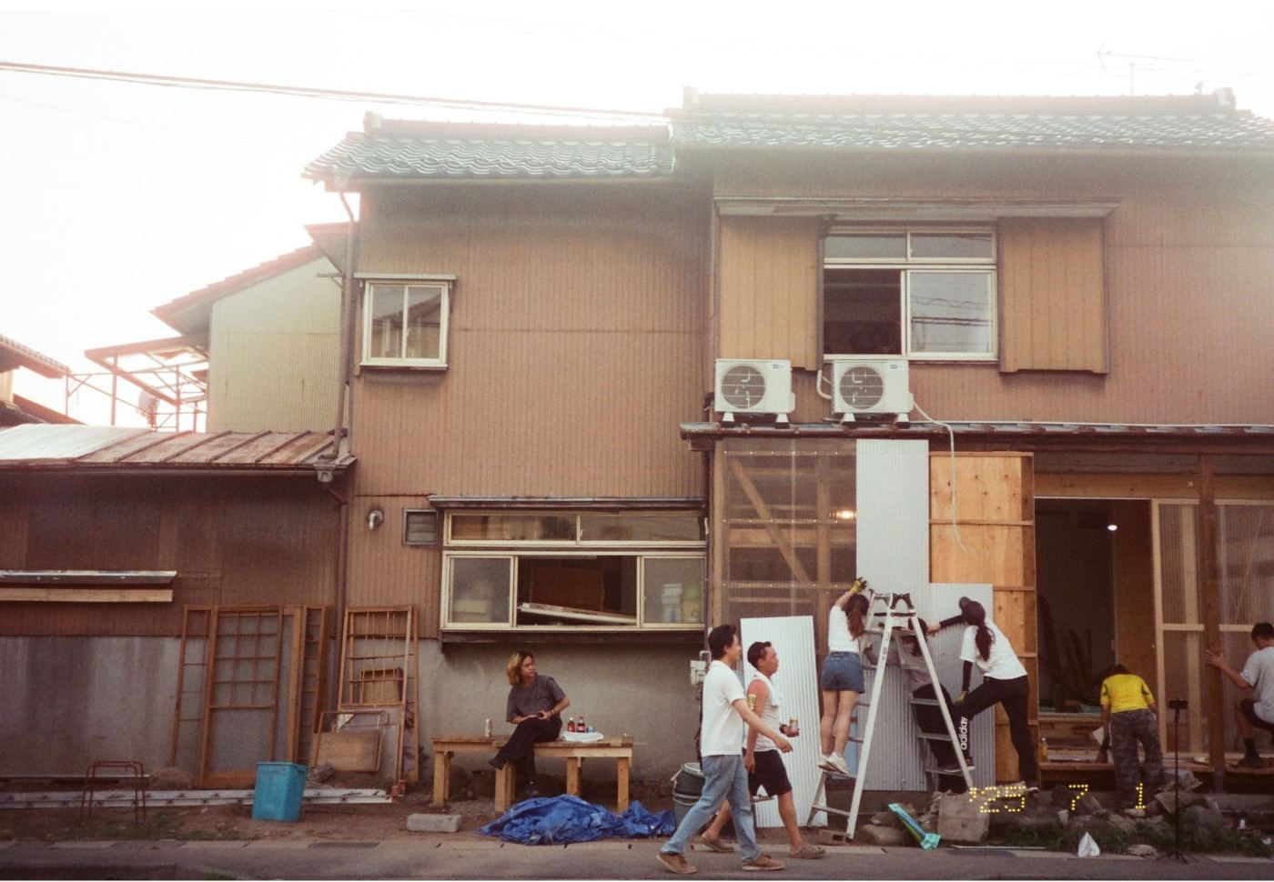 The team at work outside the two-storey timber house during the build