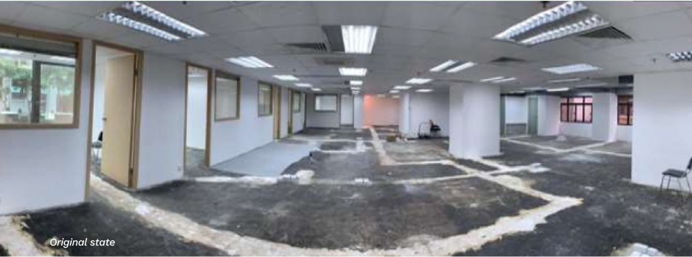 The empty office floor before the works, with bare concrete patches and exposed ceiling